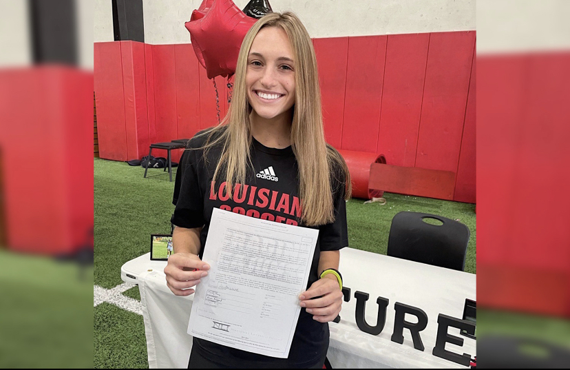 Senior+Ally+White+holds+her+newly+signed+Letters+of+Intent.+White+will+be+playing+at+University+of+Louisiana.