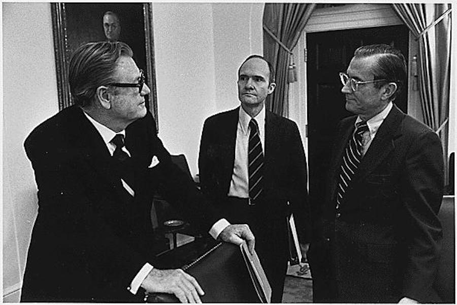 Former CIA Director William Colby (right) talks with former Deputy Assistant for National Security Affairs Brent Scowcrof (middle) and former Vice President Nelson A. Rockefeller (left) about the Vietnam War during a break from a meeting of the National Security Council on April 24, 1975.