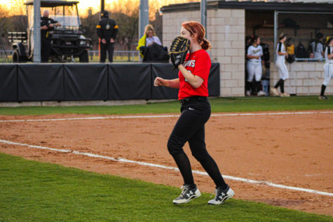Junior Emily Aronson waits for the ball to strike the bat, hoping to get an out for her team. With redemption on the minds of the Redhawks, the team is fired up.