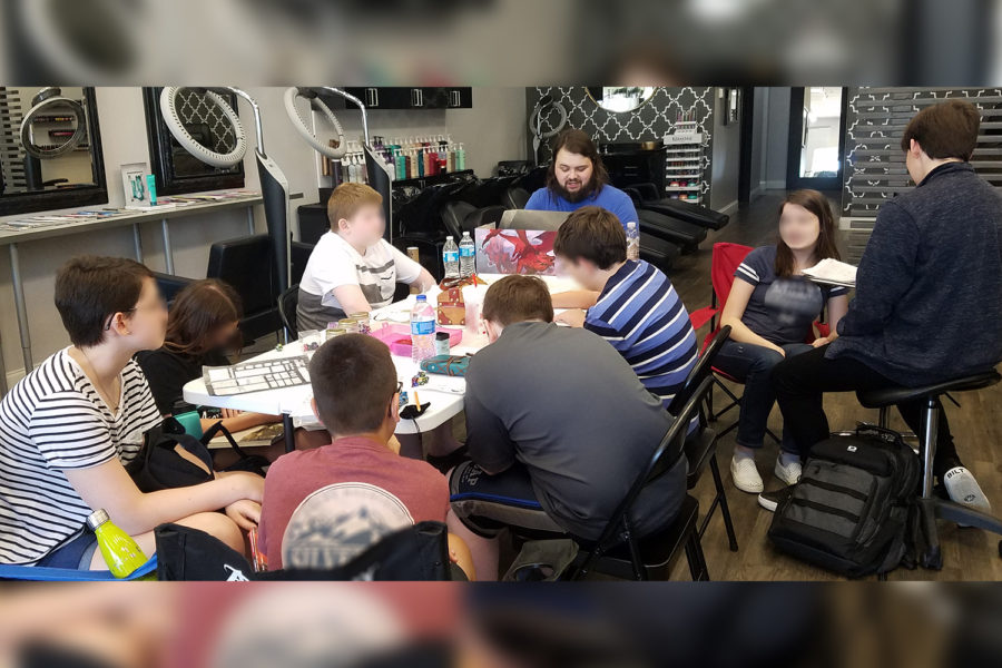 Masters of the Dungeon Verse is a small D&D club in Frisco with members gathering to play the game with several females part of the group. 