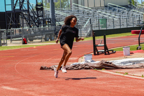 Senior Cori Ross focuses in on her finish during practice as she prepares for the State UIL meet. Accompanied by two seniors competing for the boys, the girls relay team will take the track Friday.