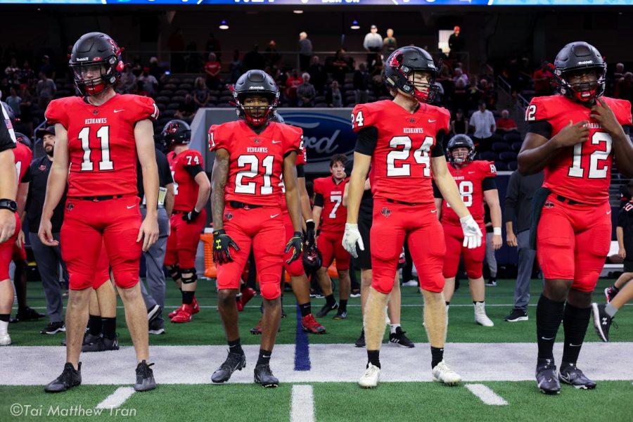 Standing at midfield, the Redhawk captains (Ford Shippy #11, Chris Johnson #21, Jack Bryan #24, and Keldric Luster #12) get ready to  walk to the center of the field at the Ford Center. Facing off against Lake Dallas in District 7-5A action, the Redhawks earned their 5th straight win 41-24.