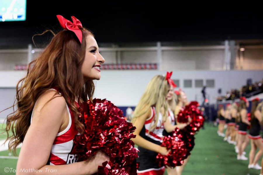 On the side at the Ford Center, junior Allie Elgin and the rest of the Redhawk cheerleaders try to get the crowd fired up at the Homecoming game on Thursday, Sept. 23, 2021. The Redhawks moved to 5-0 with their 41-24 win over Lake Dallas. 