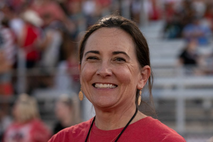 Standing on the sidelines at Kuykendall Stadium, principal Ashley Rainwater takes in the Redhawks win over Prosper Rock Hill. 