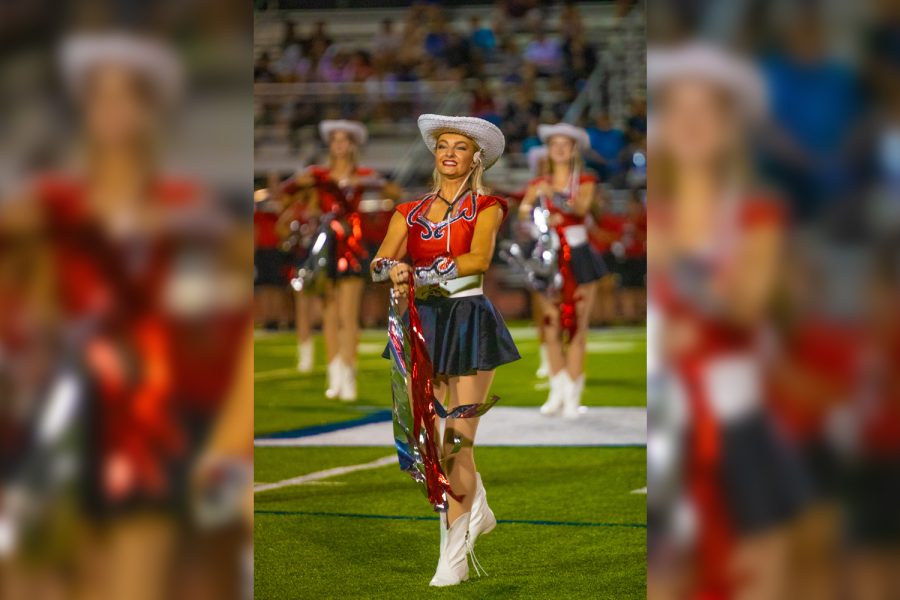 Performing during halftime of the Redhawks football game against Rock Hill, Red Rhythm captain Kelsey Madden stands on the field with the rest of her team.