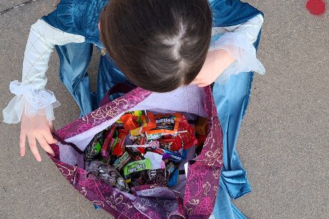 Taking a look at her stockpile of candy, 10-year-old Piper Higgins tries to decide what she wants to eat.  My dad lets us have a few pieces of candy before we go home, she said. 
