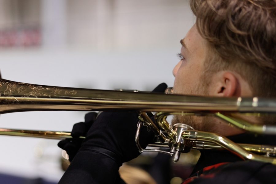 Playing the trumpet, senior Jack Pyatt and the reset of the Redhawks band play during the Homecoming football game at the Ford Center on Sept. 23, 2021. 
