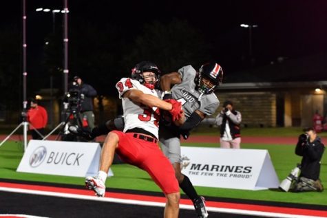With :14 left on the clock in the fourth quarter and Redhawks clinging to a three point lead, senior Sam Wenaas battles Lovejoys Kyle Parker for the ball in the corner of the Leopards end zone. 