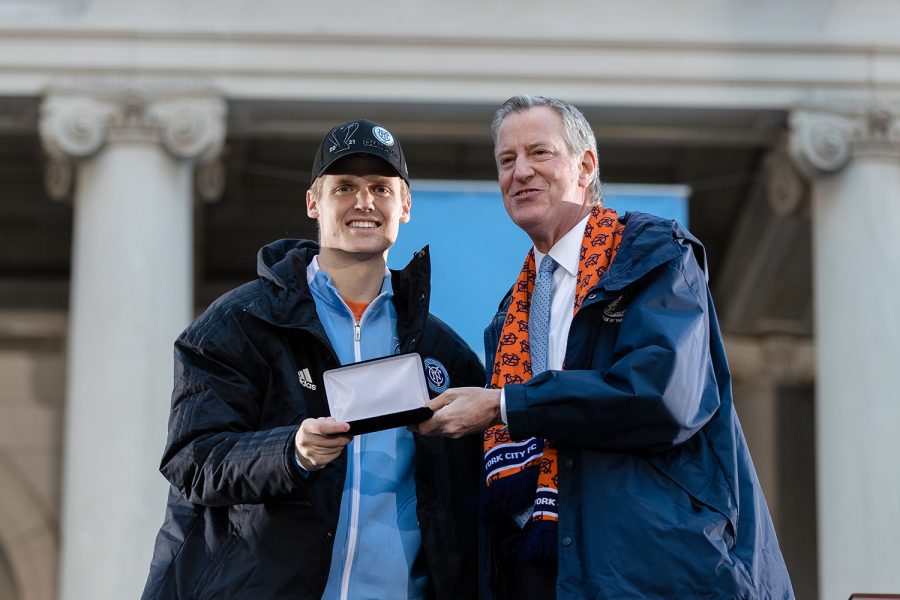 Standing in front of City Hall in New York City, former Redhawks soccer player Keaton Parks stands with NYC Major Bill de Blasio after receiving the key to the city in a ceremony on Dec. 14 to honor the MLS Cup champions: the NYCFC.