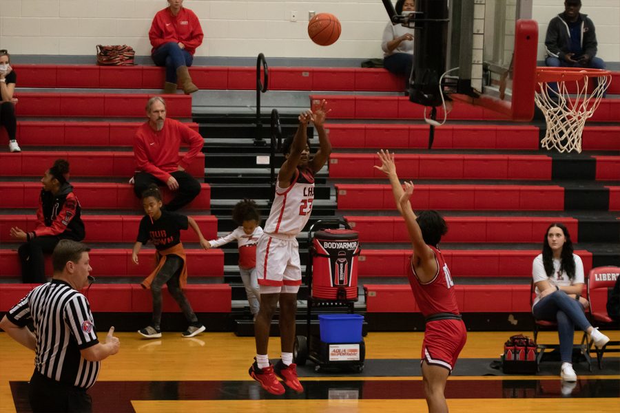 (23) Jacobe Coleman looks to sink a shot against the Centennial Titans. With a win streak on the line, the Redhawks hope to put up a fight against the Coyotes.