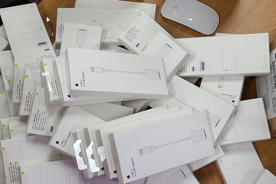 More than 60 USB-C to USB adapters are piled on top a desk in room C102. With the new iMacs having no USB ports, the adapters are necessary in the Audio/Video production classroom as the video cameras record on SD cards. 