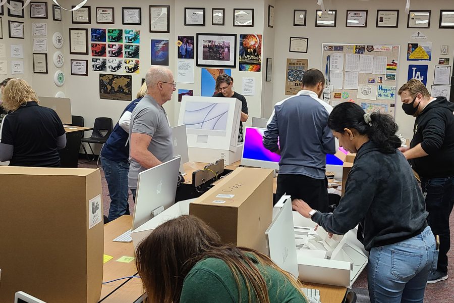 A crew of 10 Frisco ISD technology workers spent several hours in C102 removing all the Apple iMacs and installing news iMacs on Friday, Jan. 28, 2022. While the room was being worked on, the classes of journalism teacher Brian Higgins relocated to the library. 