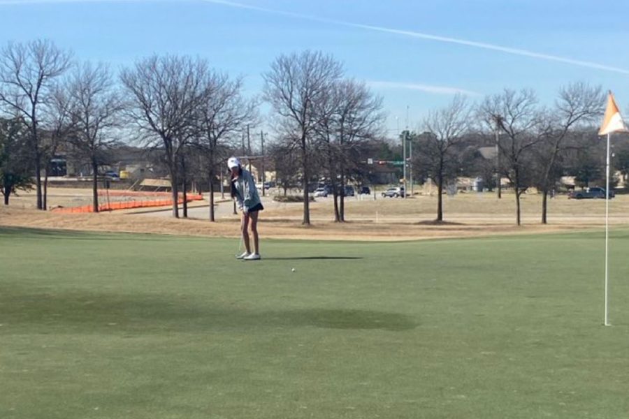 Freshman Brittney Zhang takes her putt on the par-5 13th hole.