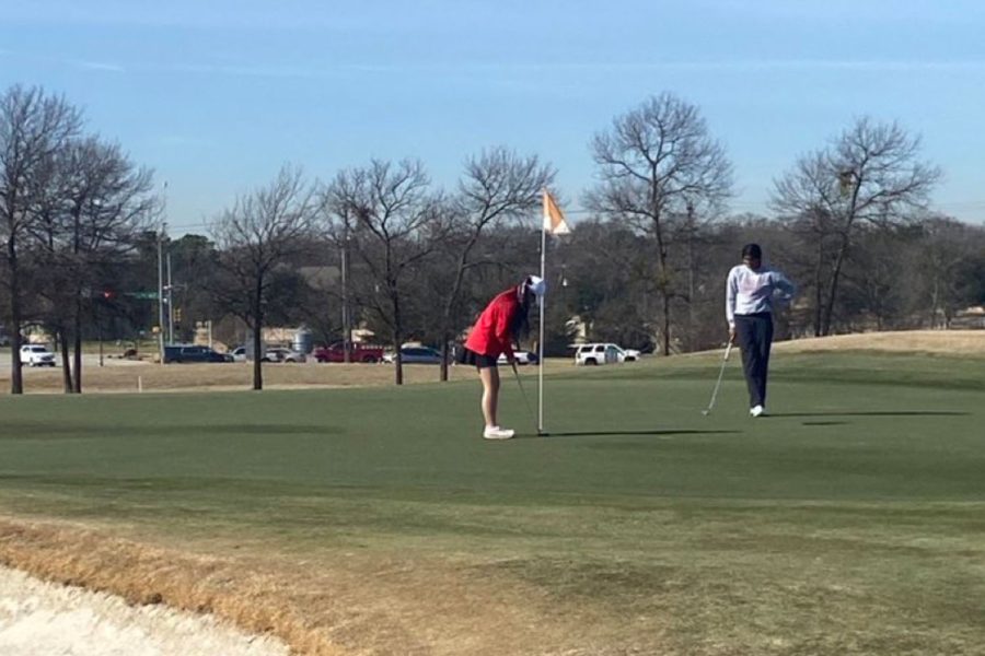 Freshman Alanna Chang gets ready to hit her putt on the 13th green.