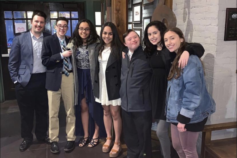 Posing for a picture, Best Buddies vice president Marcela Perdron (center) smiles with former club members at the 2019 Friendship Ball. After two years of absence, the dance will be returning this Saturday, and Buddies will be returning to the dance floor.