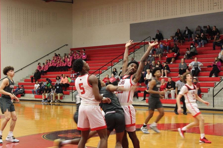 With Redhawks on either side, the Heritage Coyotes struggle to find an open shot. With Coyotes eager to score, #5, Jonathan Dupree-Buford, and #23, Jacobe Coleman, block the shot.