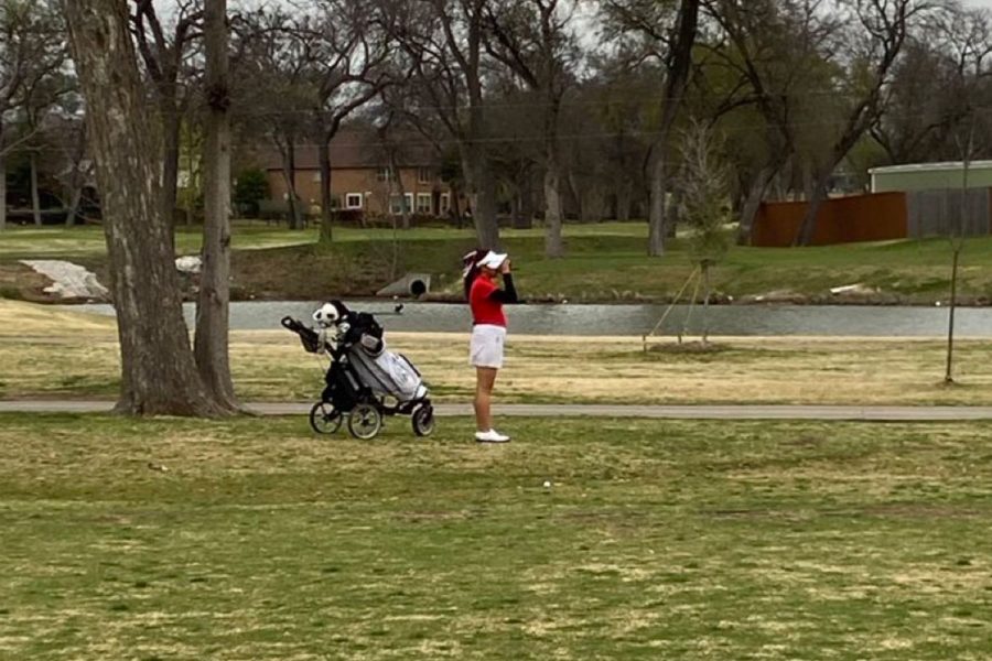 Freshman Abigail Lee checking her yardage for her approach on the 2nd hole, beginning day 2.