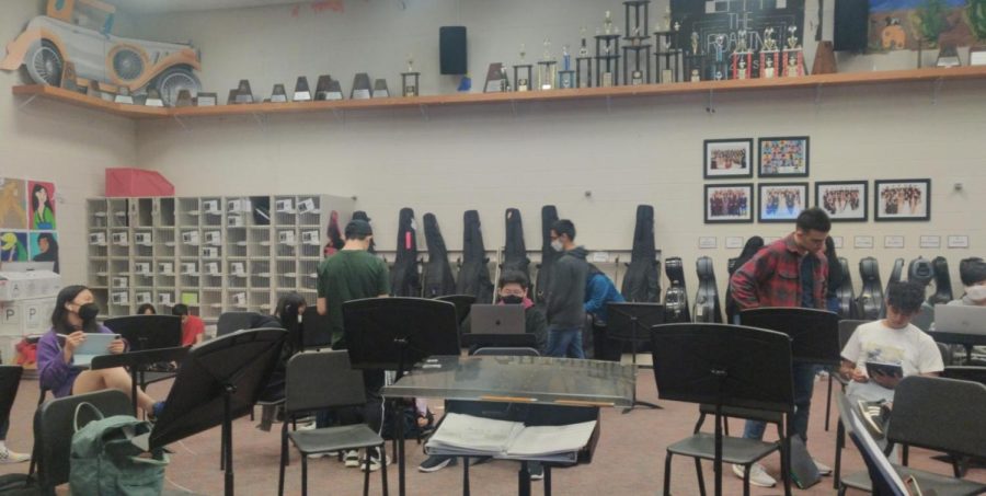 Orchestra students stand in the room getting ready to rehearse during 3rd period Wednesday. Students and directors hold mixed feelings about having a rehearsal extension on their UIL performance. 