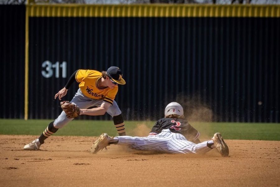 With his hands already on second base, senior Lawson Towne beats the tag of the Memorial shortstop for one of his 25 stolen bases. 