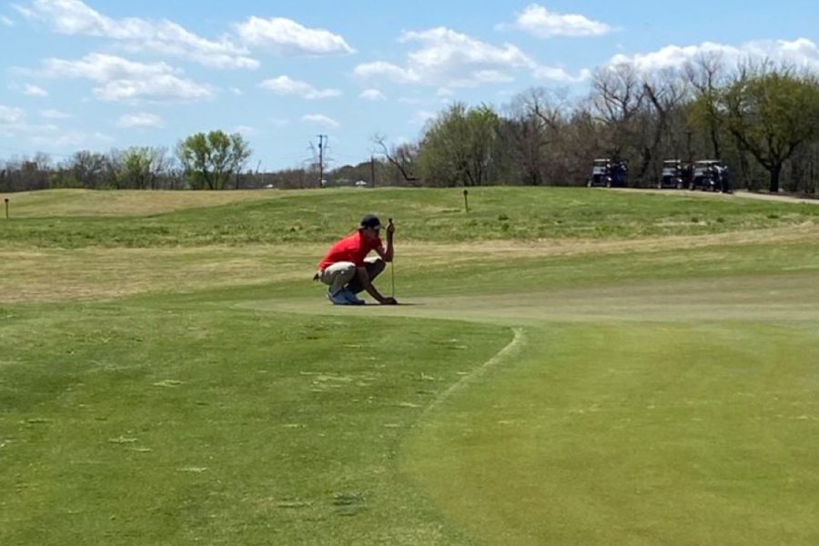 Senior Thaxton Nelson sets up for his putt on the 17th on day 1.