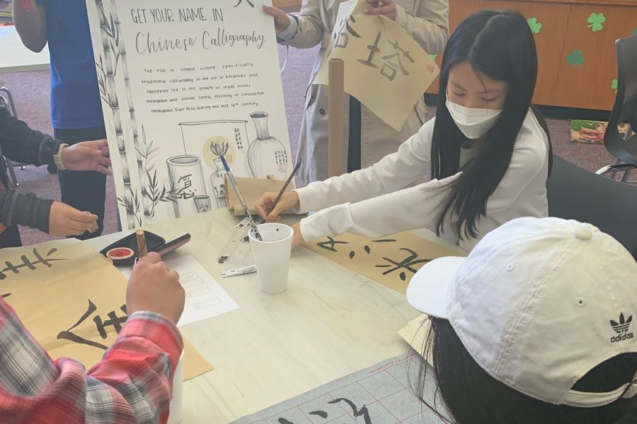 Humanities students participated in the Renaissance fair Tuesday and Wednesday. One group pictured above had visitors learn and try Chinese calligraphy.