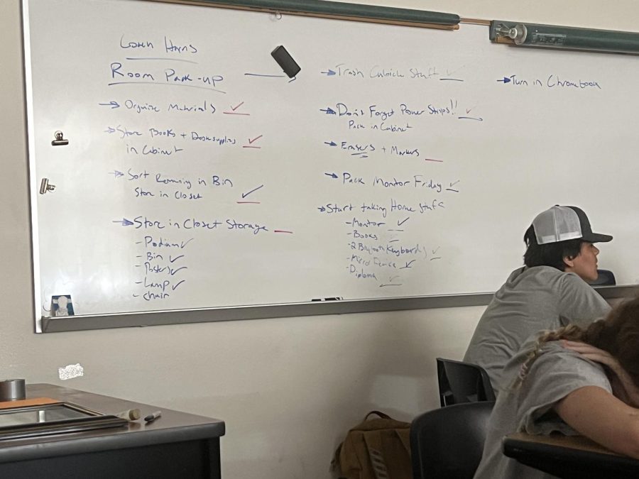 Coach Allen Harris sets a to-do list for cleaning out his classroom. All teachers are required to have their classrooms completely cleaned out by the end of the year for the campus refresh.