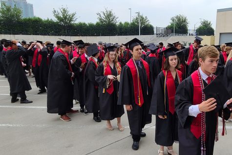 Graduates line up outside the Ford Center prior to the class of 2022 graduation ceremony. The class of 2023 graduates Saturday at noon. 