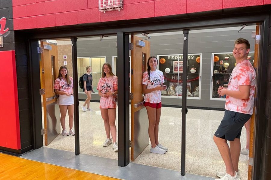 Student Council members Lily Leyden, Finley Lofgren, Mary Jane McCurdy, and Scott McCord (left to right) waited at the doors of the gym. They greeted students as they filed in to play bingo. 