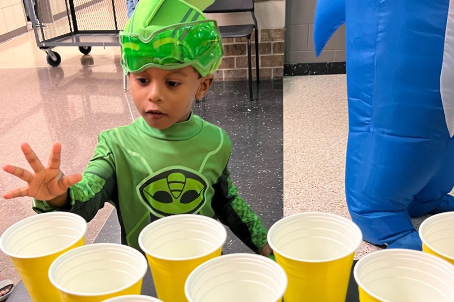 A young boy makes his shot at Wingspans Honey Dunk table which  ask people to throw a ping pong ball into a cup on the table. Each person was given three attempts with a piece of candy given for every made shot. 
