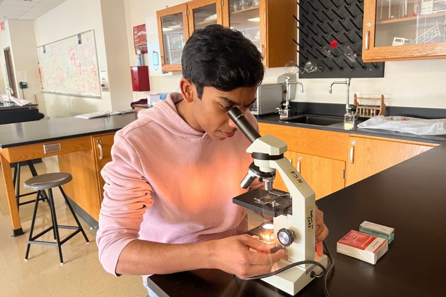 Vishnu looks through the microscope and observes algae. Vishnus interest and curiosity in science has led him to discover other passions.