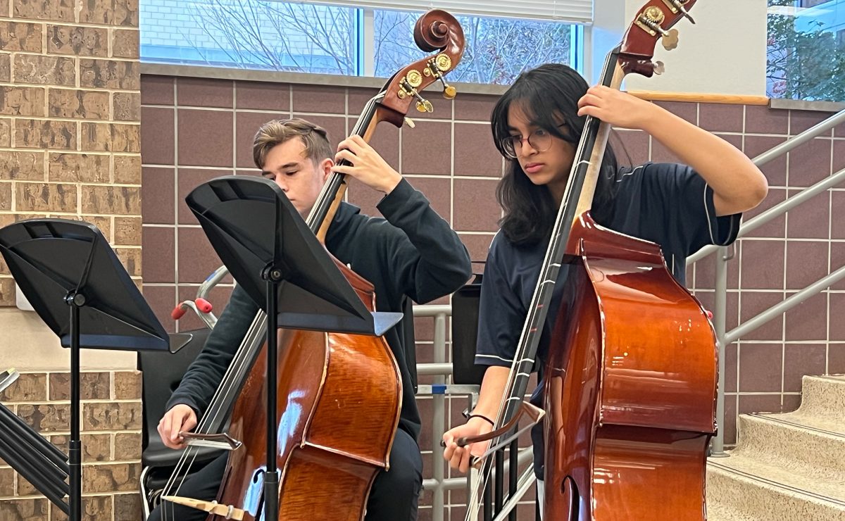 Bass players junior Tyler Mannis and sophomore Mehira Alla are the foundational instruments of the orchestra.