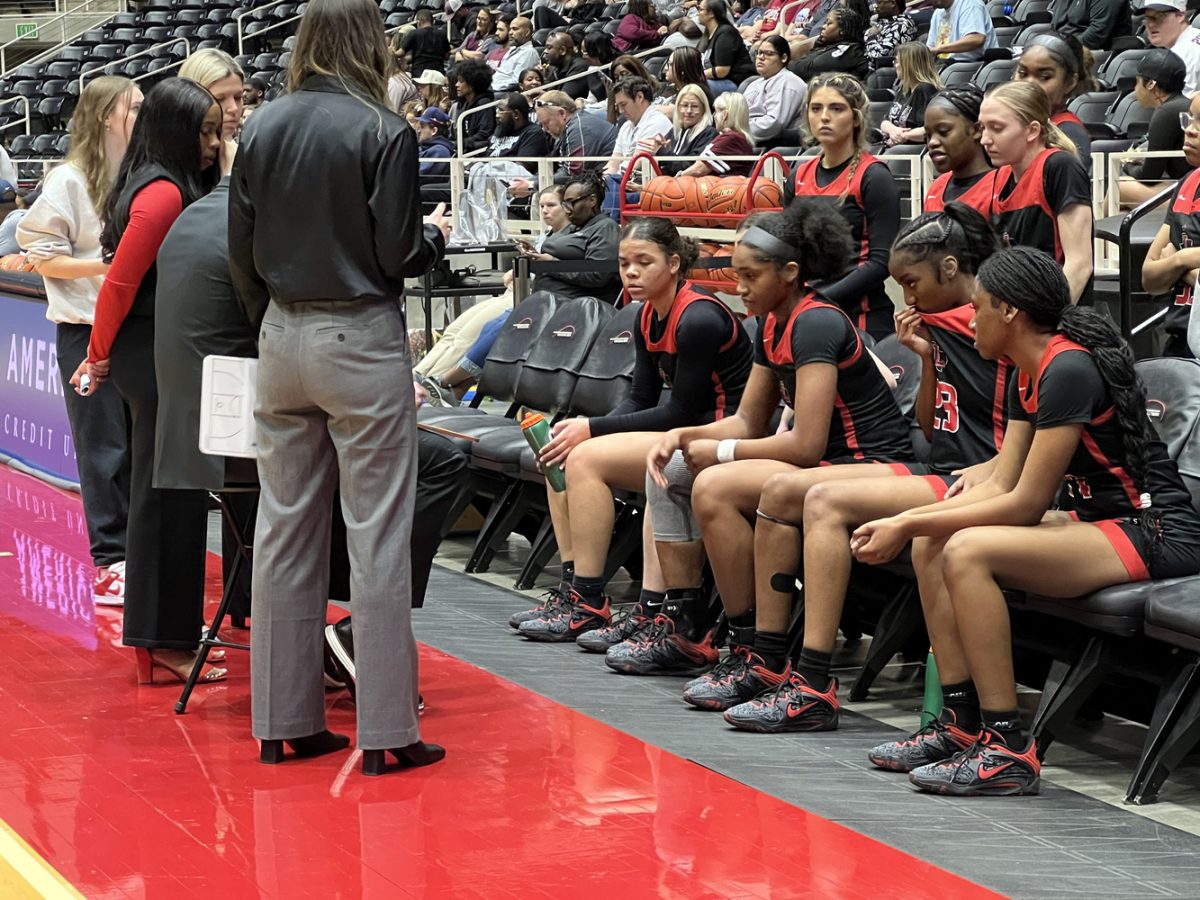 With time running down in the teams 53-26 win over Princeton in the 5A Region II final, the girls basketball team listens to head coach Ross Reedy during a timeout. 

Winning the 5A Region II final allows the team the chance to earn its second straight 5A championship.