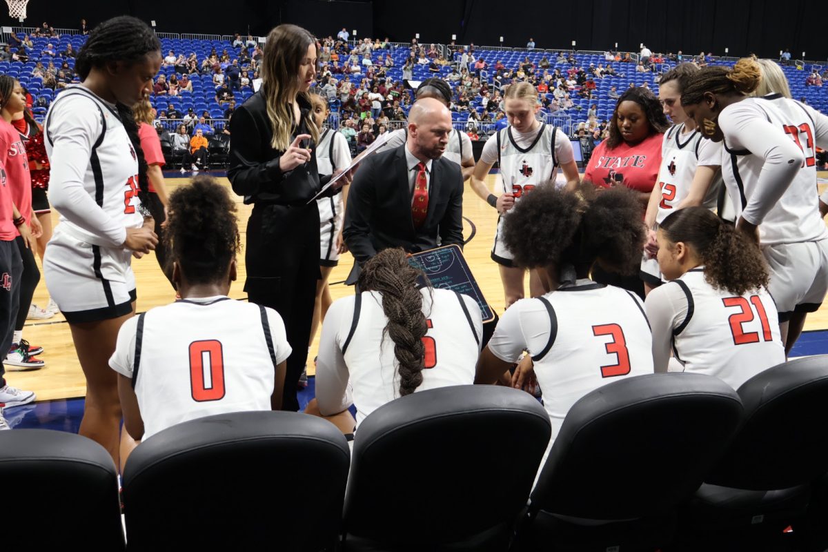 With his team huddled around him before the game, head coach Ross Reedy talks to the Redhawks about what they need to do in order to beat the states #1 ranked team: Mansfield Timberview. 