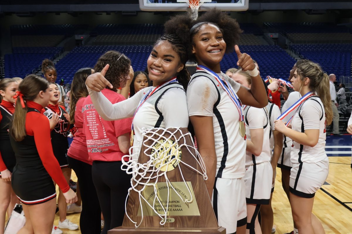 After winning their second straight state championship and going back to back in San Antonio, senior Keyera Roseby and sophomore Jacy Abii stand back to back as they hold the UIL 5A championship trophy. 