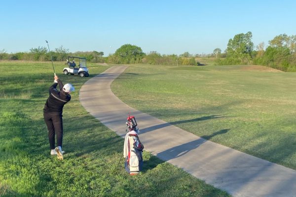 Just off the cart path, freshman Wyn Shippy drives towards the green. With a  top two finish in the District 10-5A tournament at The Bridges Golf Club on Tuesday and Wednesday the Redhawks will advance to the regional tournament. 