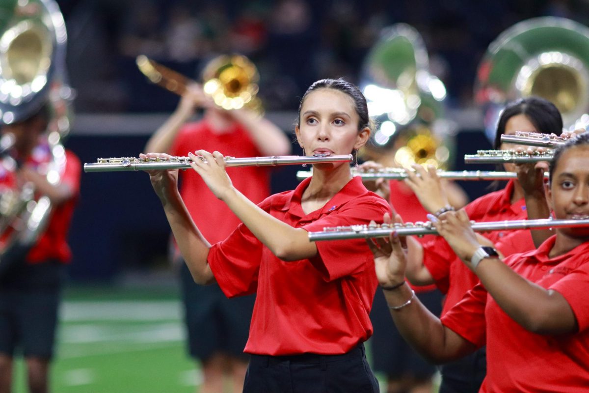 The Redhawk marching band is leaving The Nest on Tuesday to show off all they have learned and practiced at the Frisco ISD Marching Band Showcase at the Ford Center. Pictured is sophomore Natalie Marshall, a flute player in the marching band. 
