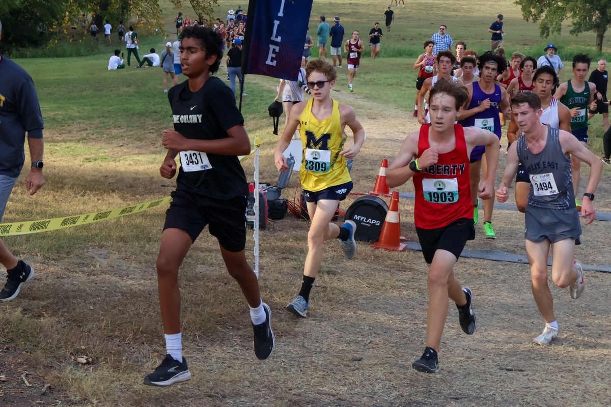 Freshman Eric Pratt pushes up a hill on a challenging course at Myers Park in McKinney.