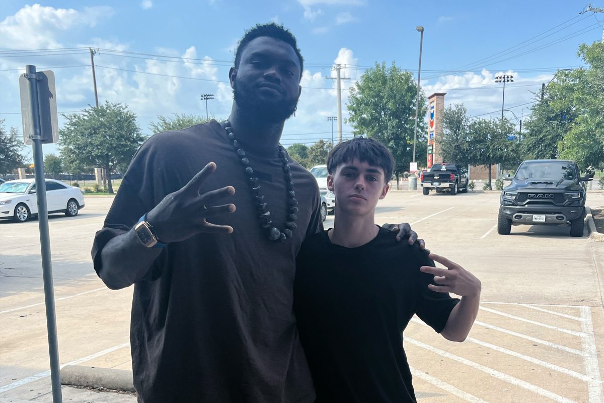 Standing outside Krab Kingz restaurant in Little Elm, junior Owen Higgins poses with NBA star Zion Williamson of the New Orleans Pelicans.
