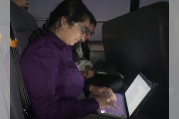 Lincoln-Douglas debater, junior Neha Ramachandran researches potential arguments on the early morning bus ride to Melissa High School.