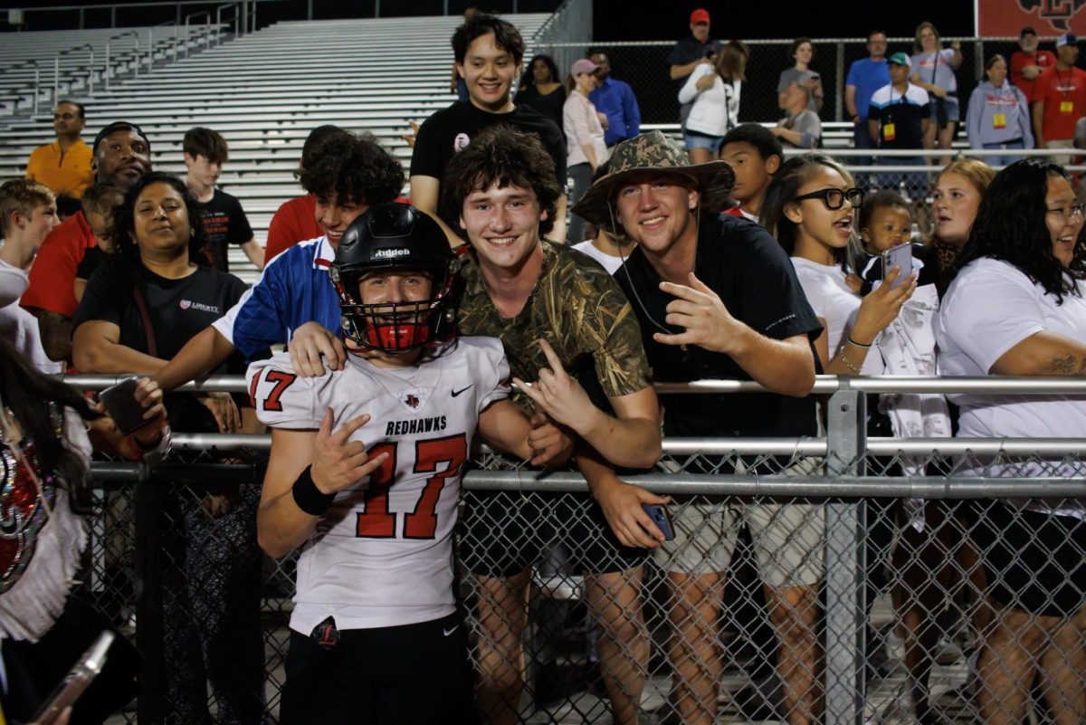 Wide receiver Landon Reygadas poses for a photo commemorating the win with friends senior Luke LeBlanc and Jonathan Banks. 