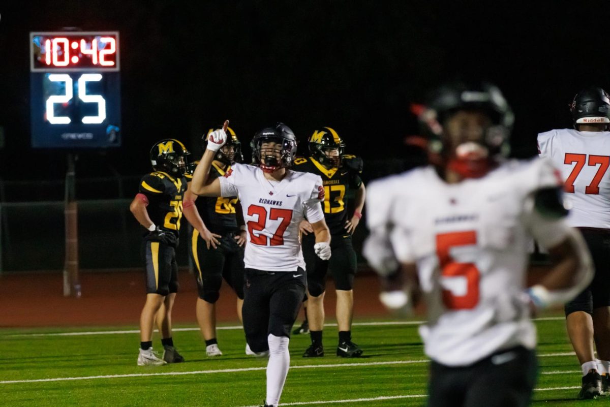 Patrick Rowe points to the sky, thanking the heavens as he runs away from the endzone. 