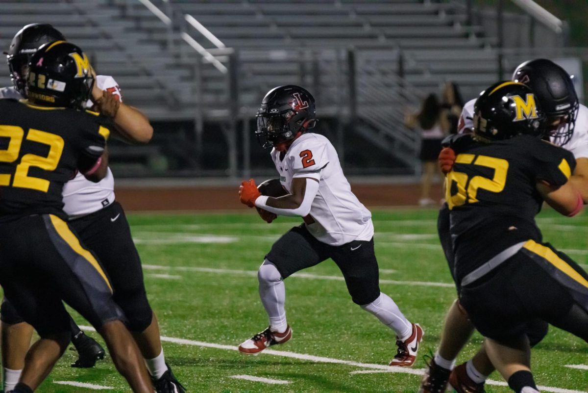 Daniel Essien runs against the gradient, pushing on as the Warriors try to block him from the endzone.