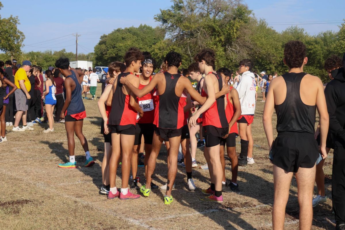 Senior Regional Qualifier Dominic Ward leads a huddle with the boys varsity cross country team shortly before their race began