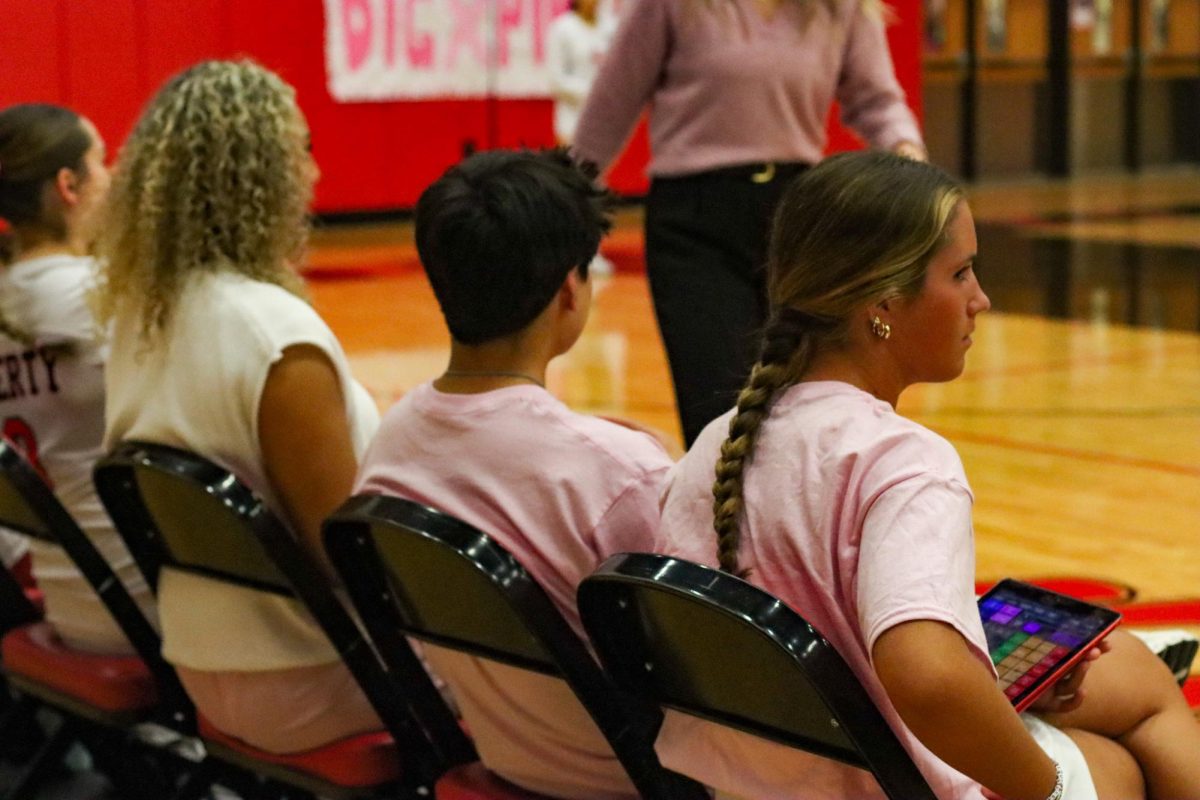 The managers of the volleyball team are not exempt from pinking out, as they wear matching pink shirts. 