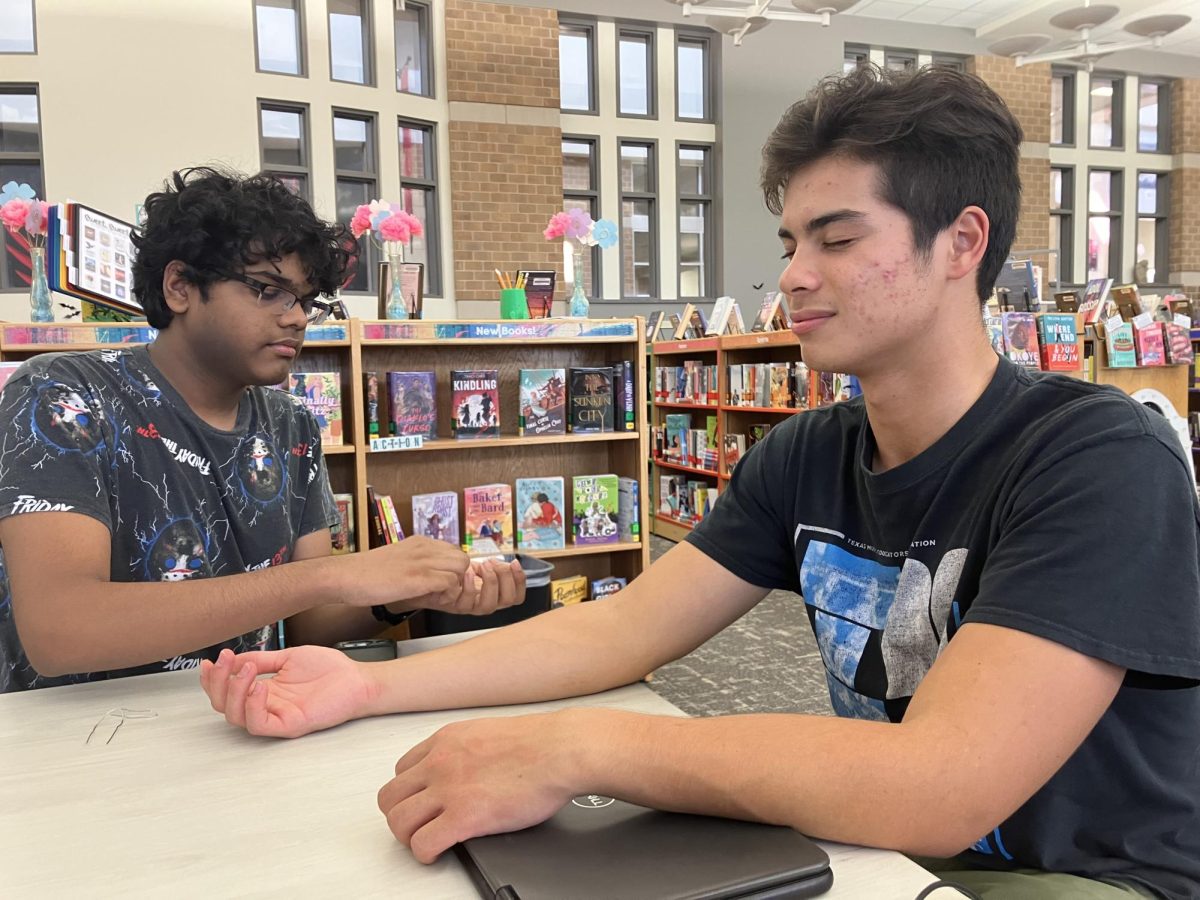 Junior Sirish Shabash tests junior Todd Stile’s perception of different twisted paperclips on various places of the arm and hand.

