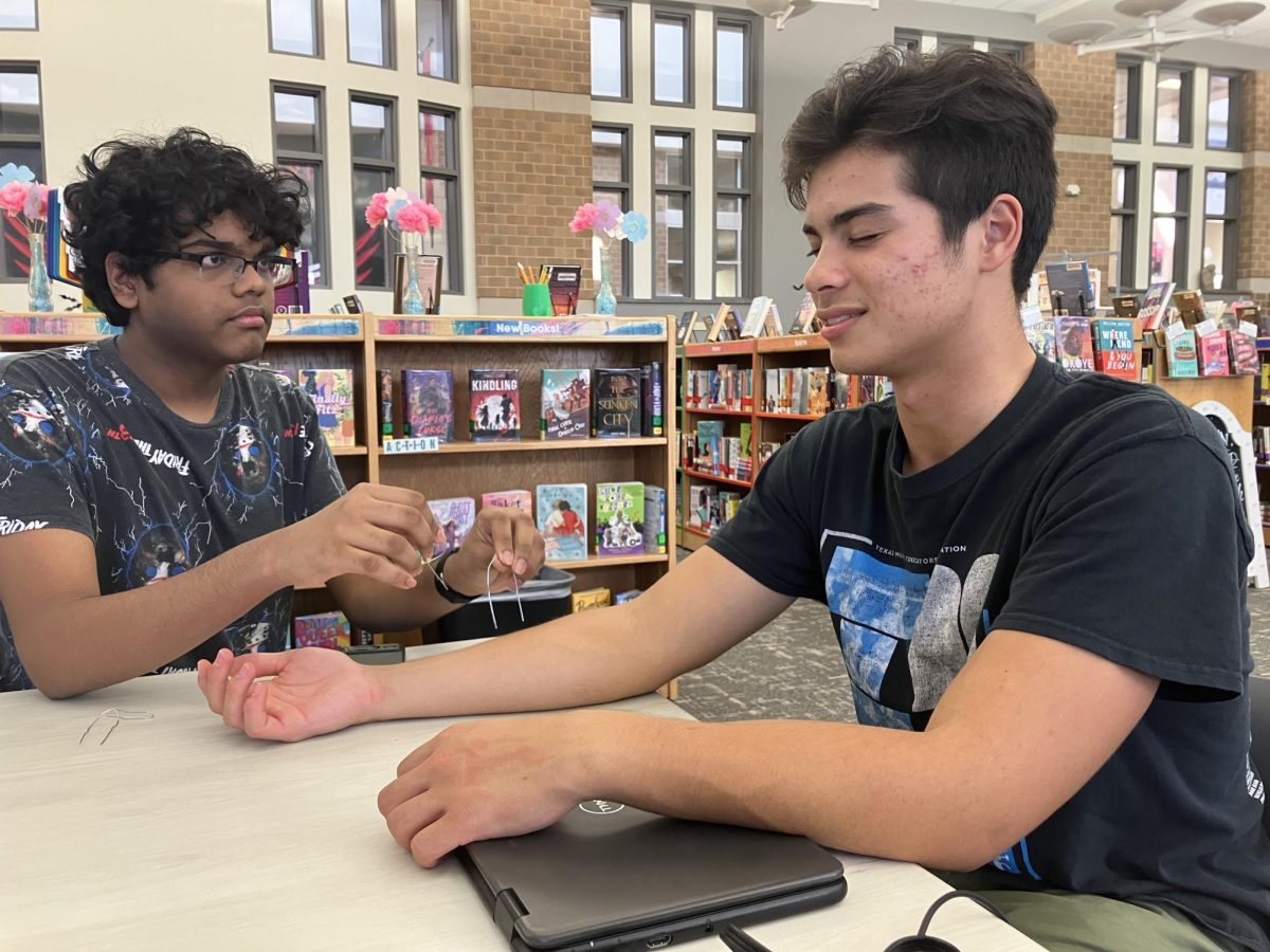 Junior Sirish Shabash tests junior Todd Stile’s perception of different twisted paperclips on various places of the arm and hand.
