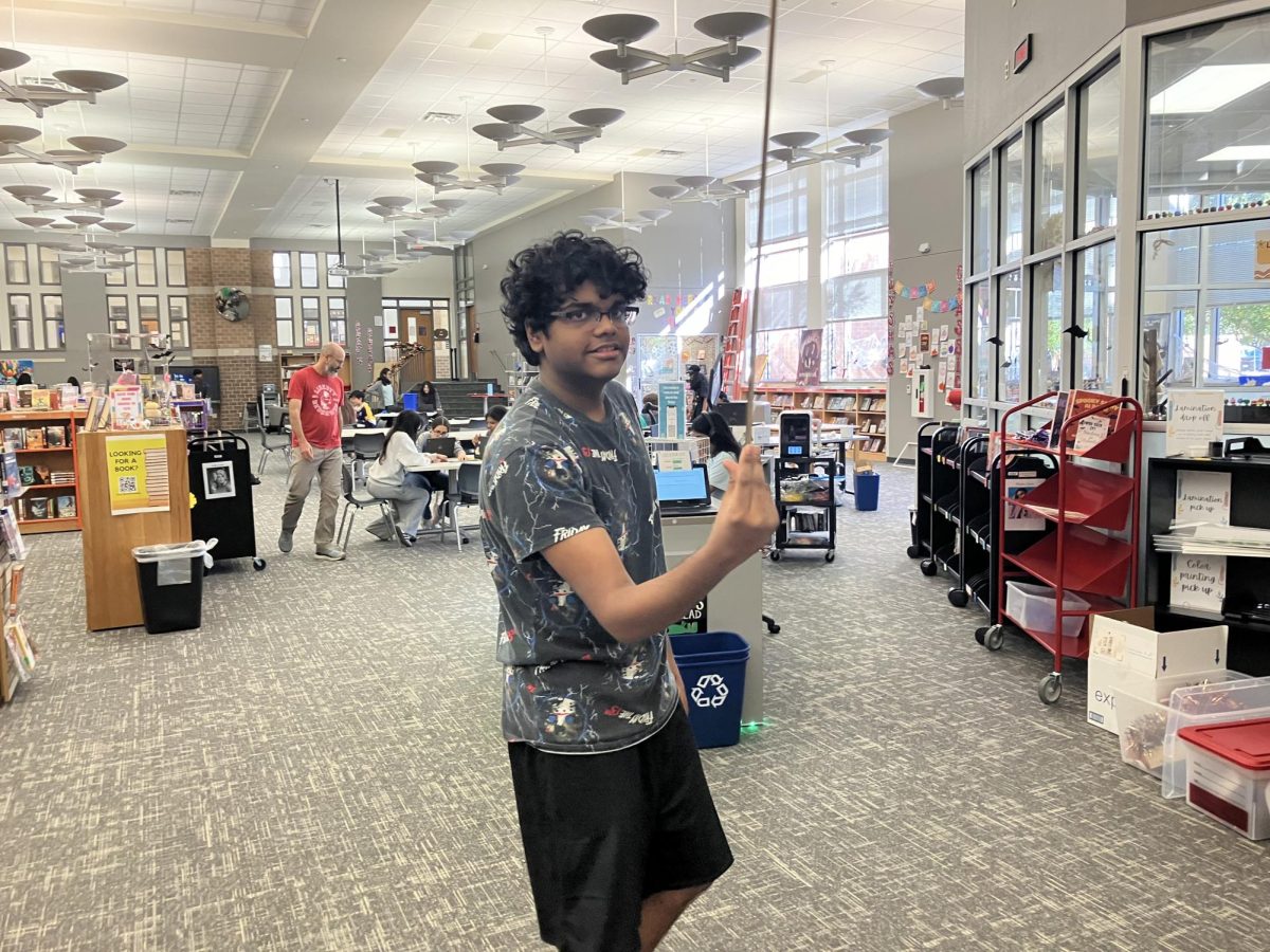  Junior Sirish Shabash sees how long he can balance a yardstick on his hand to analyze his senses and perception. Shabash’s longest time was seven seconds.
