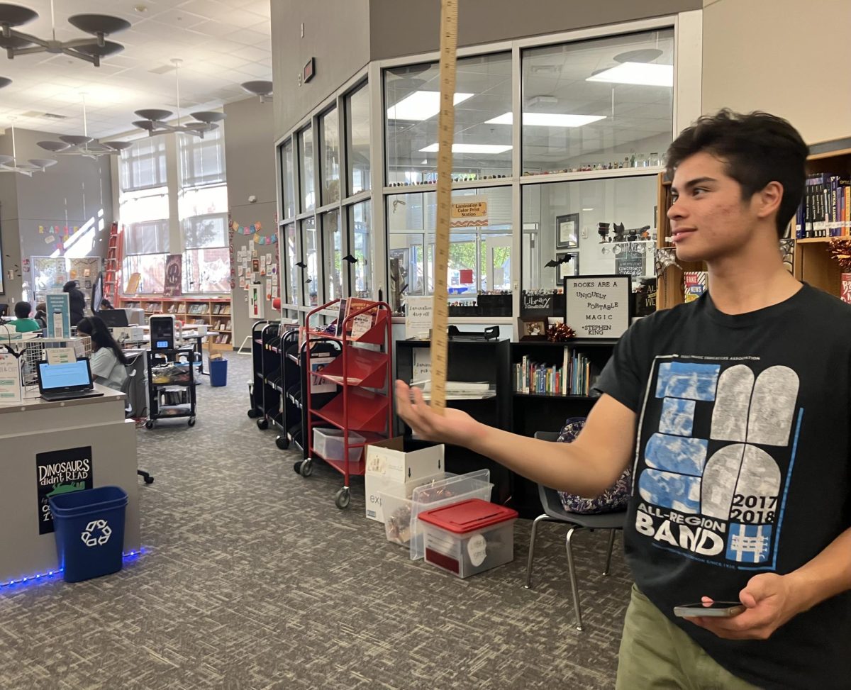 Junior Todd Stiles sees how long he can balance a yardstick on his hand to analyze his senses and perception. Stiles' longest time was 11 seconds.
