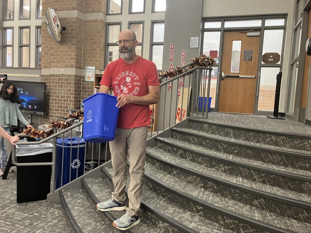 AP Psychology teacher Tim Johannes prepares to instruct his class on the final station, a psychological test to see who could correctly guess which color of marker was in a recycle bin several times in a row.