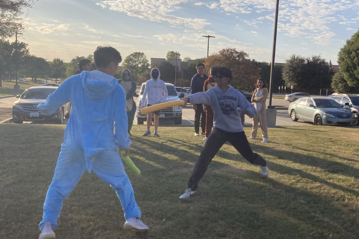 Junior Minseok Kim and sophomore Sid Parigi fence with pool noodles on behalf of their pods.